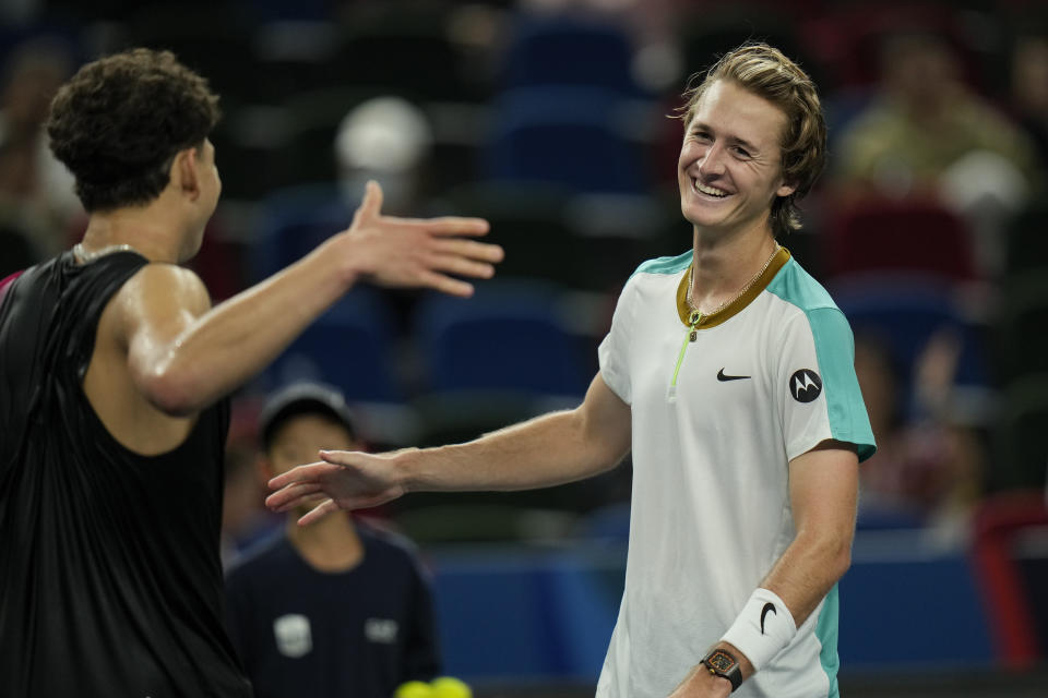 Sebastian Korda of the United States, right, shakes hands with his compatriot Ben Shelton after beating him in the men's singles quarterfinal match of the Shanghai Masters tennis tournament at Qizhong Forest Sports City Tennis Center in Shanghai, China, Thursday, Oct. 12, 2023. (AP Photo/Andy Wong)