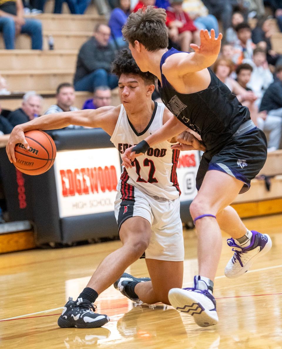 Edgewood's Mialin White (22) goes behind the back to get around Bloomington South's Andrew Baran (5) during the Bloomington South versus Edgewood boys basketball game at Edgewood High School on Tuesday, Nov. 22, 2022.