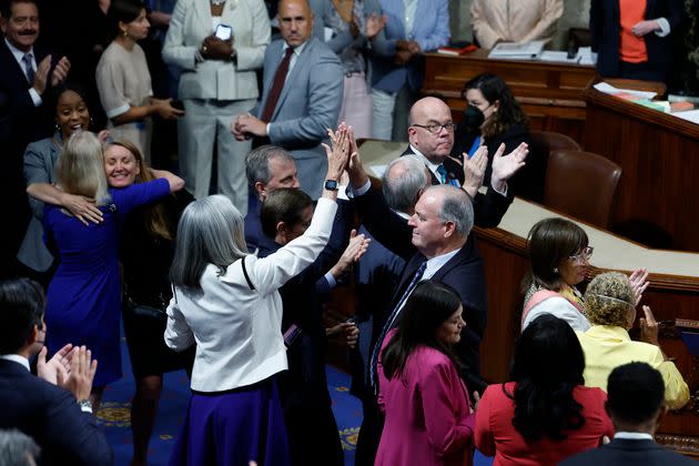 Democratic members of the House celebrate on the House floor after passage of the Inflation Reduction Act on Aug. 12. The bill passed with 158 members voting by proxy, which allows them to have their votes counted despite being physically absent. (Photo: Chip Somodevilla via Getty Images)