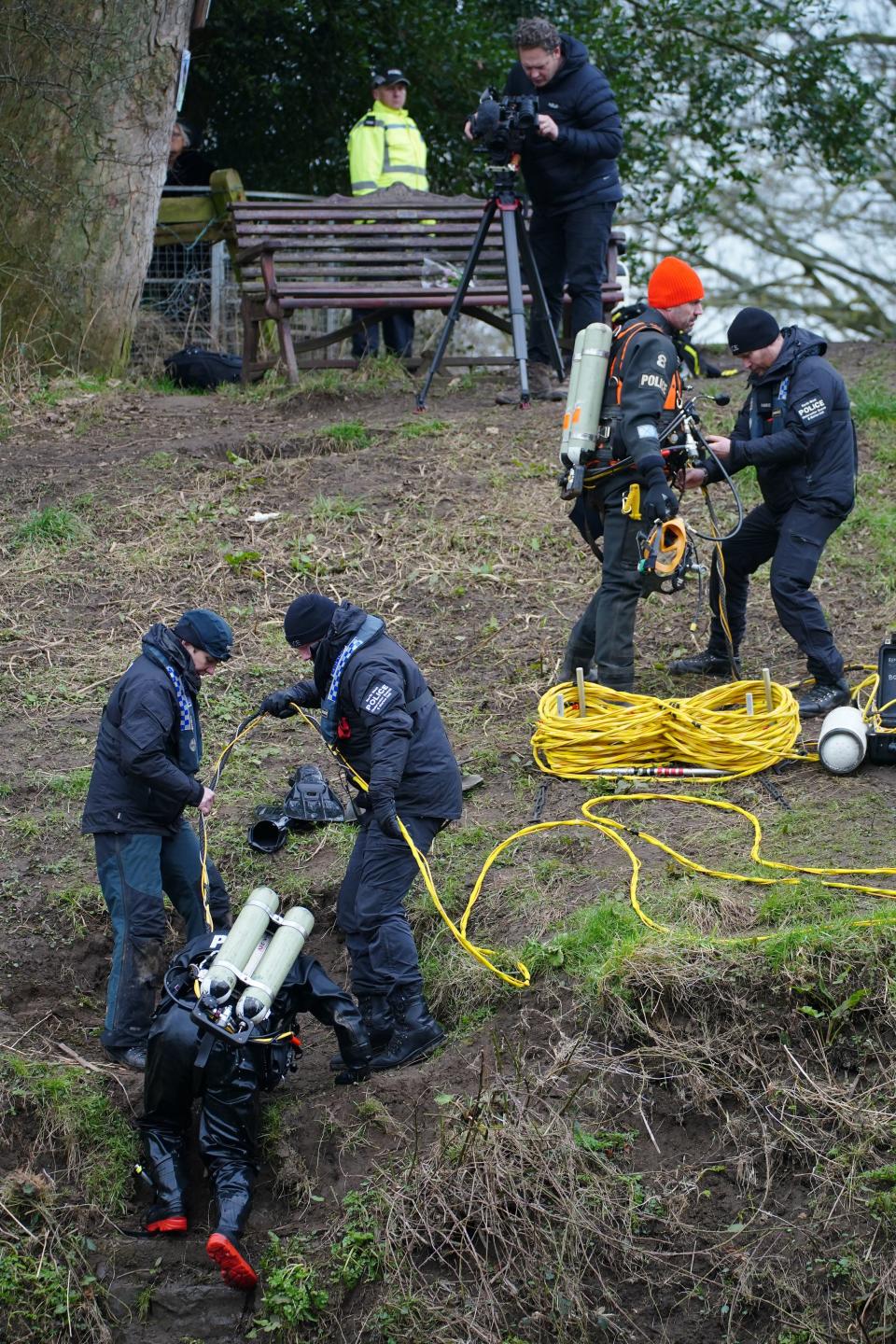 Divers enter the river next to the bench where Nicola Bulley’s phone was discovered (Peter Byrne/PA Wire)