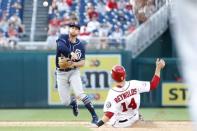 May 23, 2018; Washington, DC, USA; San Diego Padres left fielder Jose Pirela (2) turns a double play ahead of the slide of Washington Nationals first baseman Mark Reynolds (14) to end the game at Nationals Park. The Padres won 3-1. Mandatory Credit: Geoff Burke-USA TODAY Sports