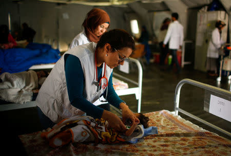 A doctor checks a patient Iraqi girl at a hospital run by Medecins Sans Frontieres in Qayyara, Iraq April 6, 2017. REUTERS/Suhaib Salem