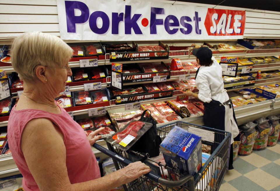 Patricia Sermeno, right, an Albertsons butcher chop employee, stacks meat at the Albertsons supermarket in Glendale, Calif., Monday April 28, 2008. The tax rebates starting to show up in Americans' mailboxes and bank accounts will likely be used for food and other basic necessities, making them less of an economic stimulus than the Bush administration hoped for.(AP Photo/Kevork Djansezian)