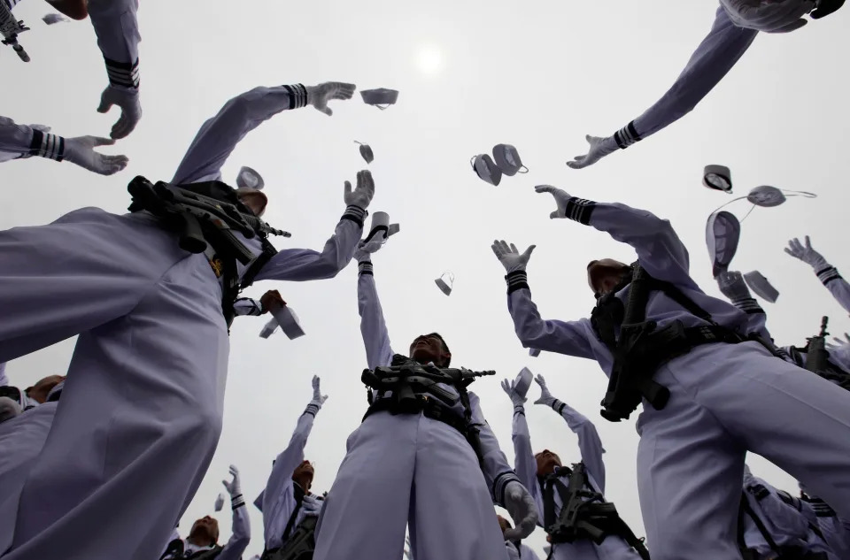 Indonesia's Navy servicemen throw their hats into the air