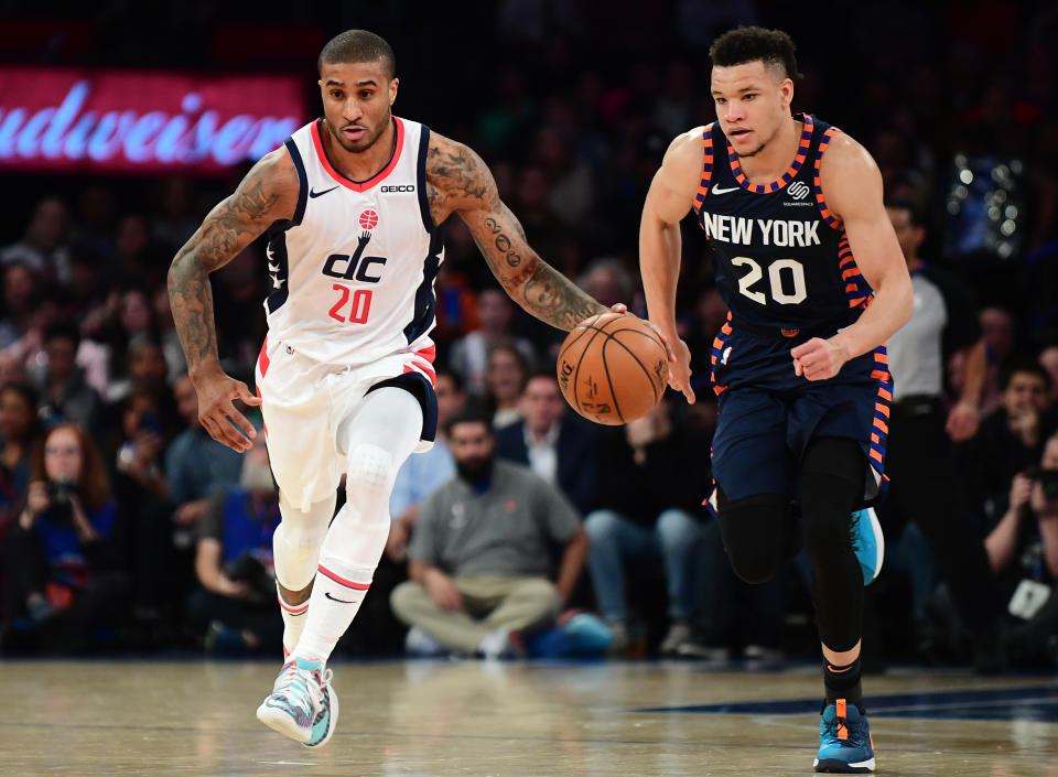 NEW YORK, NEW YORK - DECEMBER 23: Gary Payton II #20 of the Washington Wizards drives past Kevin Knox II #20 of the New York Knicks during the first half of their game at Madison Square Garden on December 23, 2019 in New York City. NOTE TO USER: User expressly acknowledges and agrees that, by downloading and or using this photograph, User is consenting to the terms and conditions of the Getty Images License Agreement. (Photo by Emilee Chinn/Getty Images)