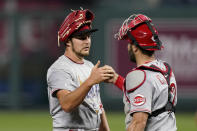 Cincinnati Reds starting pitcher Trevor Bauer and catcher Curt Casali celebrate after game two of a baseball doubleheader against the Kansas City Royals Wednesday, Aug. 19, 2020, in Kansas City, Mo. (AP Photo/Charlie Riedel)