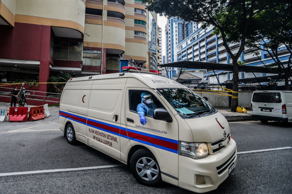 An ambulance leaves Menara City One during the enhanced movement control order (EMCO) in Kuala Lumpur April 5, 2020. — Picture by Firdaus Latif