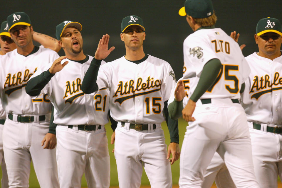 01 Apr 2002 : Tim Hudson #15 of the Oakland A's greets teammate Barry Zito #75 during the opening day game against the Texas Rangers at Network Associates Coliseum in Oakland, California. The A's won 8-3.DIGITAL IMAGE. Mandatory Credit: Tom Hauck/Getty Images