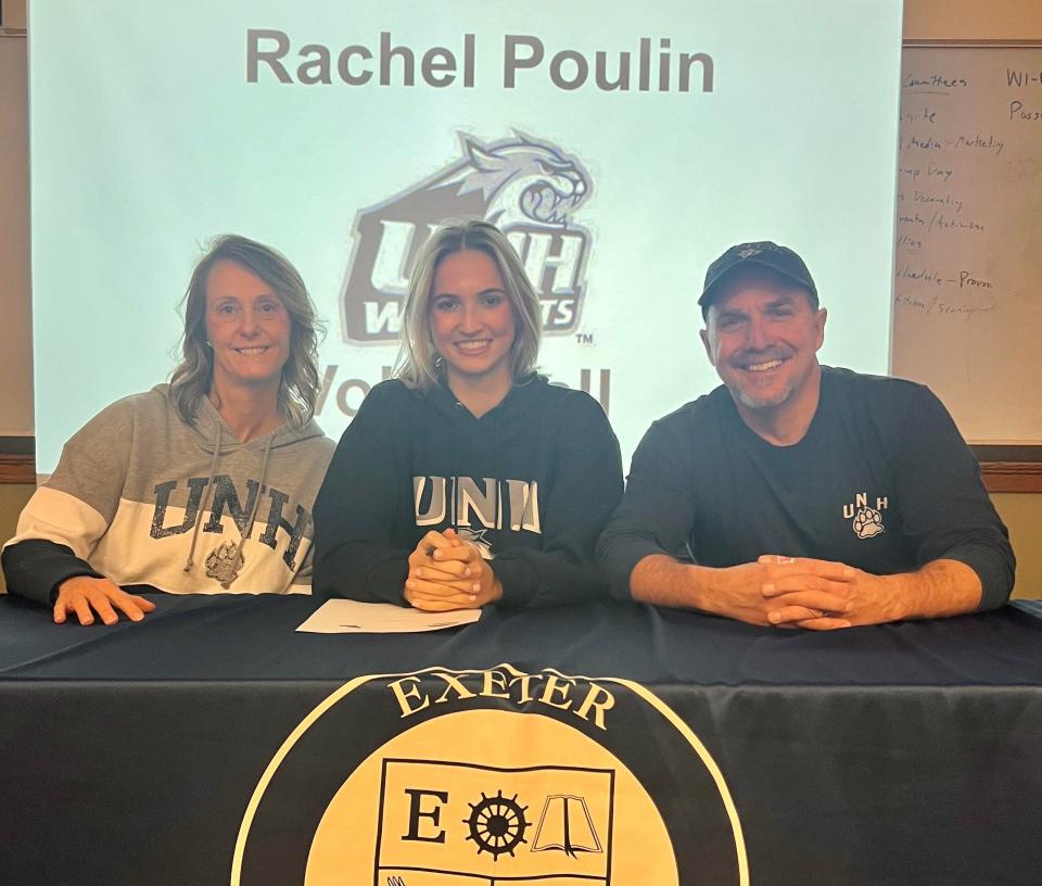 Exeter High School senior Rachel Poulin, center, sits with her family after signing her commitment to play volleyball at the University of New Hampshire.