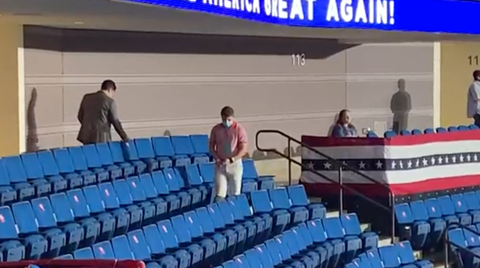 These two men were filmed removing the stickers hours before the Trump rally began. Source: The Washington Post