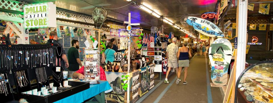 Shoppers stroll along booths at the Fleamasters Fleamarket in Fort Myers.