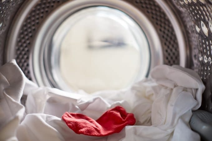 View Looking Out From Inside Washing Machine With Red Sock Mixed With White Laundry