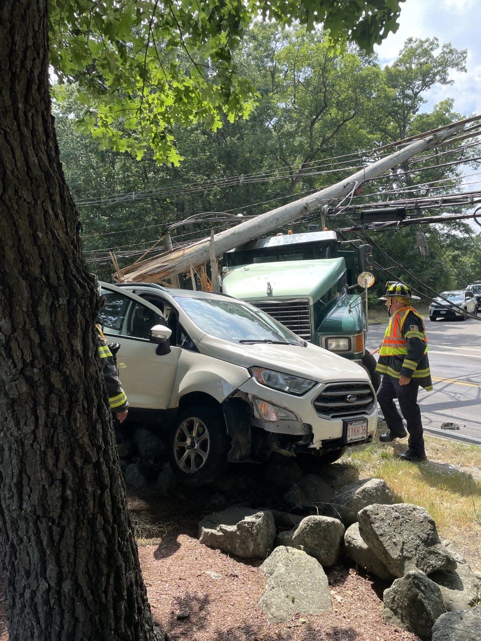 Utility lines were downed and the female driver of this SUV suffered serious injuries in a crash with a work truck in Wayland on Thursday.