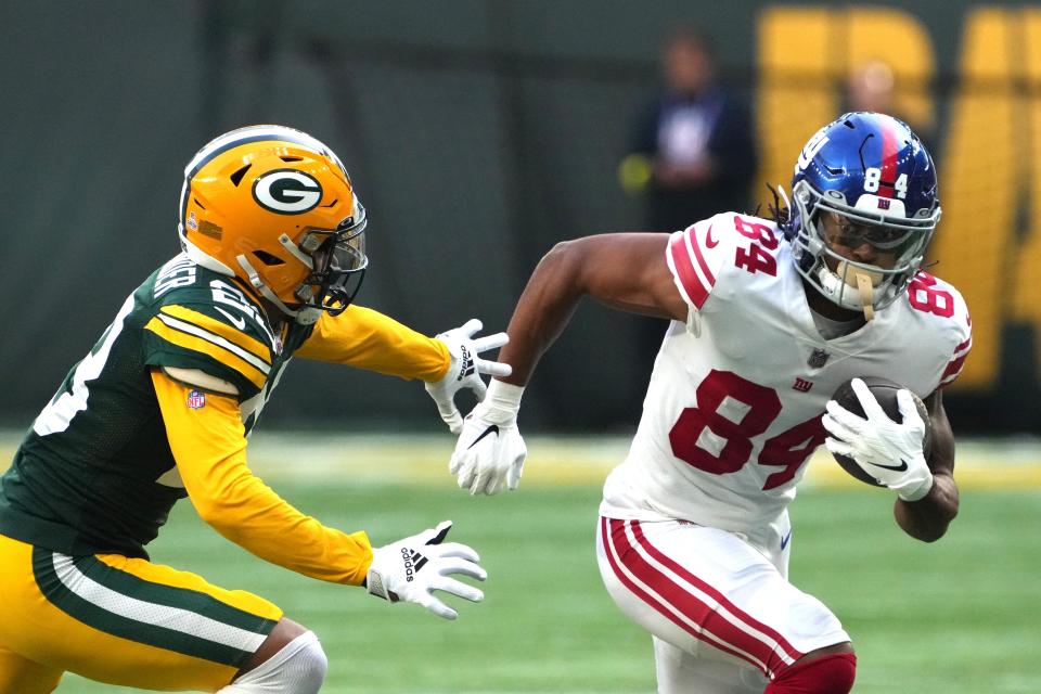 New York Giants receiver Marcus Johnson tries to elude Green Bay Packers cornerback Jaire Alexander on Oct. 9, 2022, at Tottenham Hotspur Stadium in London, England.