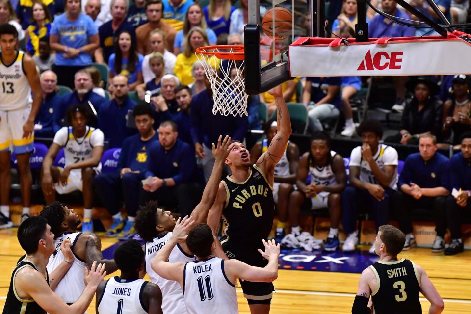 Nov 22, 2023; Honolulu, HI, USA; Purdue Boilermakers forward Mason Gillis (0) shoots a layup while defended by Marquette Golden Eagles guard Tyler Kolek (11) and guard Stevie Mitchell (4) during the first period at SimpliFi Arena at Stan Sheriff Center. Mandatory Credit: Steven Erler-USA TODAY Sports