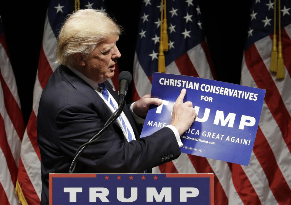 Then-presidential candidate Donald Trump holds up a "Christian Conservatives for Trump" sign at a rally on Sept. 28, 2016, in Council Bluffs, Iowa. (Photo: ASSOCIATED PRESS)