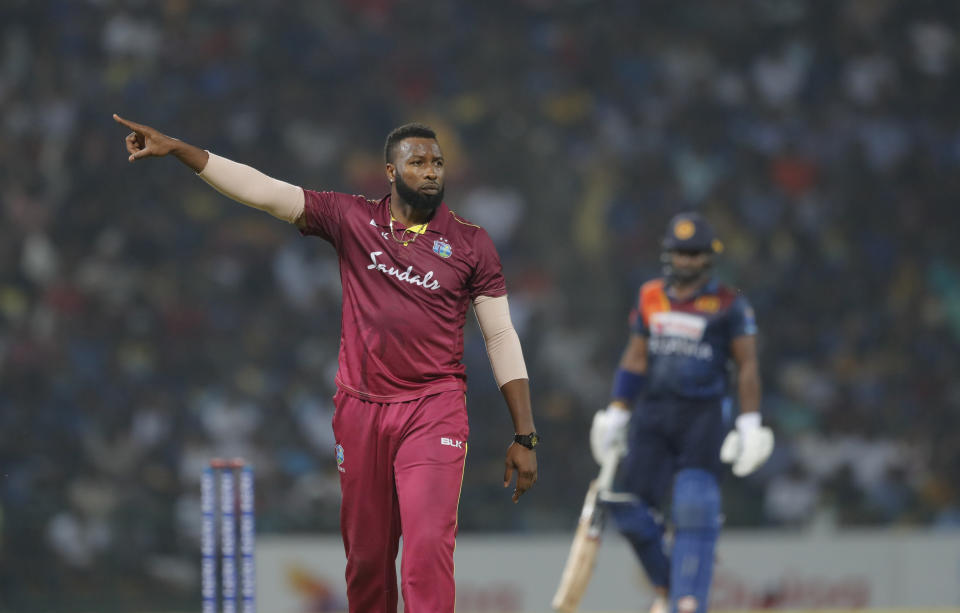 West Indies' captain Kieron Pollard gestures as he sets the field during the first Twenty20 cricket match with Sri Lanka in Pallekele, Sri Lanka, Wednesday, March 4, 2020. (AP Photo/Eranga Jayawardena)