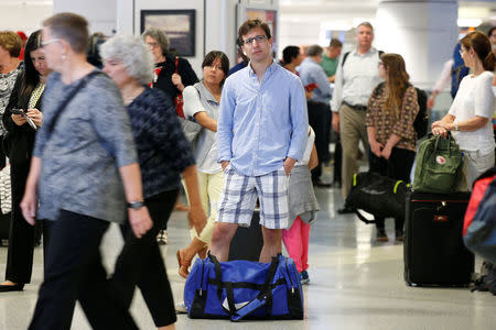 Commuters walk through New York's Pennsylvania Station which began track repairs causing massive disruptions to commuters in New York City, U.S., July 10, 2017. REUTERS/Brendan McDermid