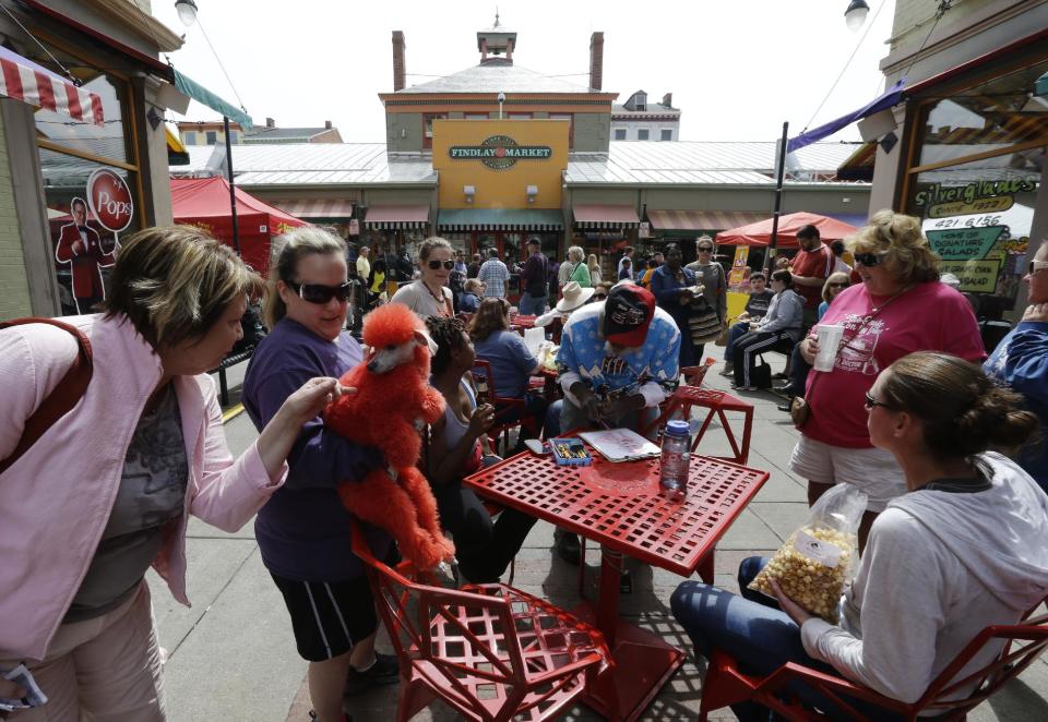 This April 14, 2013 photo shows a dyed red poodle at Findlay Market in Cincinnati. Cincinnati residents have been getting fresh meat, produce and homemade bread at Findlay Market since 1855, making it the oldest continuously running public market in the Buckeye State, (AP Photo/Al Behrman)