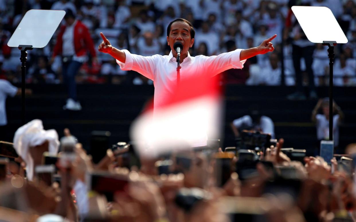 Indonesia's incumbent presidential candidate Joko Widodo gestures as he speaks during a campaign rally - REUTERS