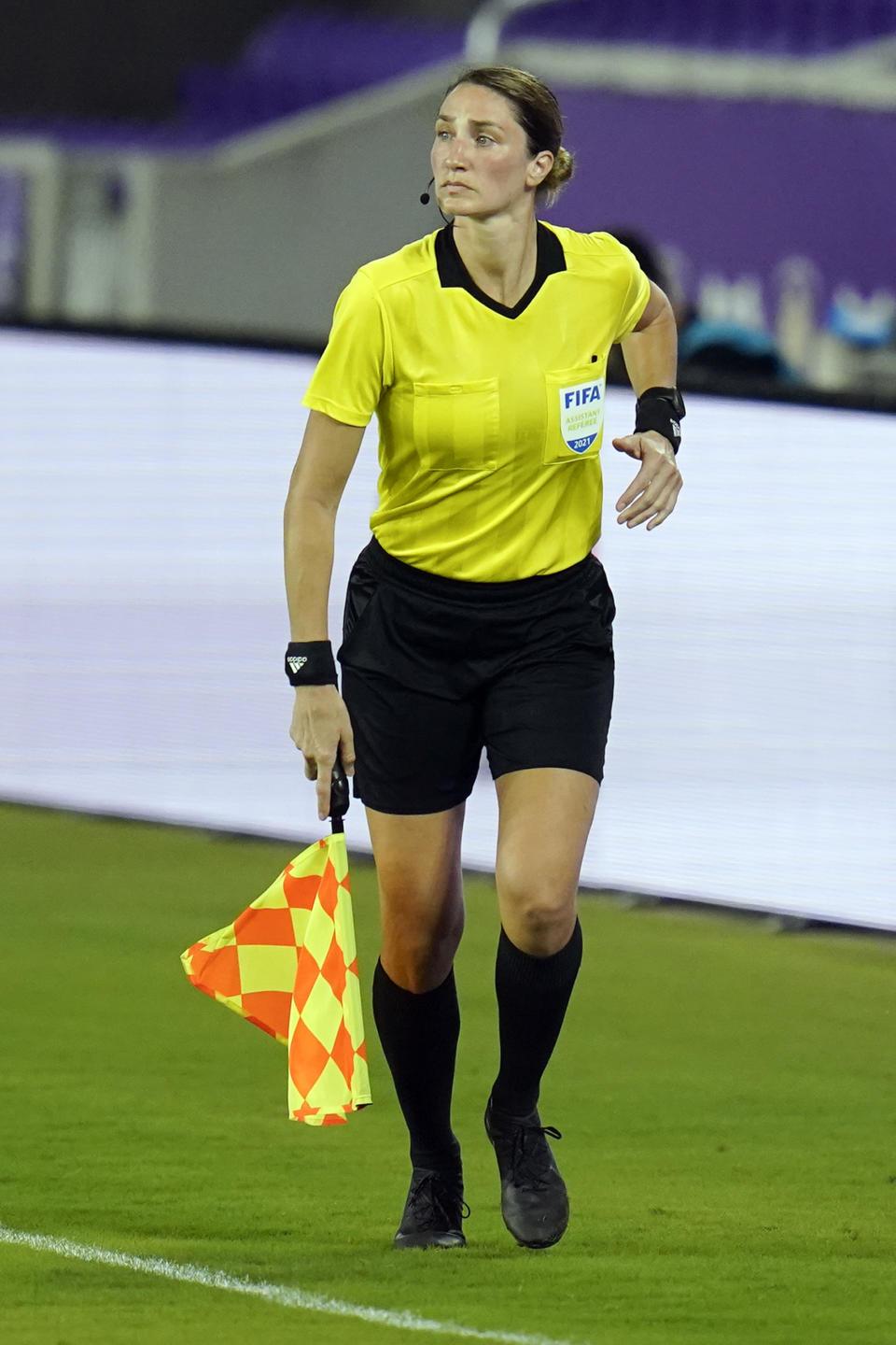 Assistant referee Kathryn Nesbitt runs the sideline as she watches play between Bermuda and Canada during the first half of a World Cup 2022 Group B qualifying soccer match, Thursday, March 25, 2021, in Orlando, Fla. Nesbitt, a 32-year-old from Philadelphia, had a breakthrough moment when she became the first woman to work as an on-field official for a World Cup qualifier in North and Central America and the Caribbean.(AP Photo/John Raoux)