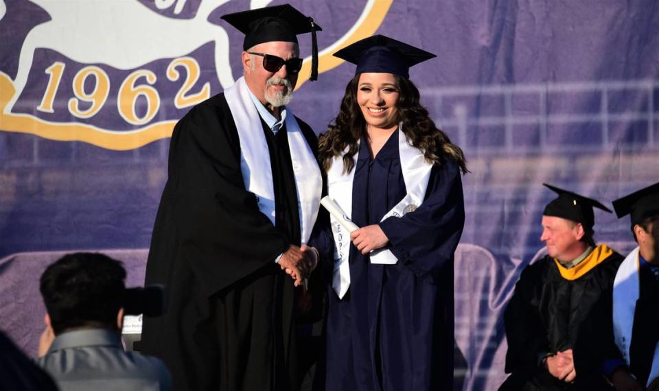 Merced College graduate Andrea Sprague Cortes receives her degree from Merced College Board of Trustees President John Pedrozo during the school’s 60th commencement ceremony on Friday, May 26, 2023.