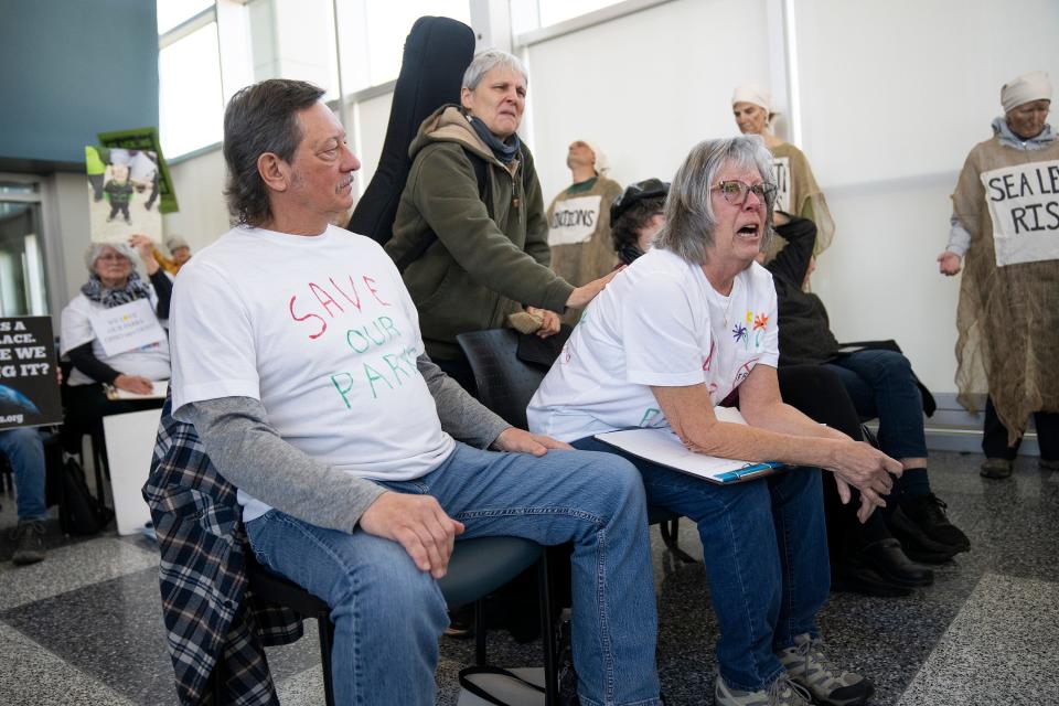 Terri Sabo is comforted by Jenny Morgan as she cries and speaks out in protest during a meeting of the The Ohio Oil and Gas Land Management Commission at the Charles D. Shipley Building Atrium. Sabo is seated next to her husband Rick Sabo, the two live next to Salt Fork Park.