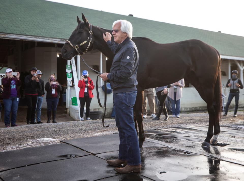 Trainer Bob Baffert holds Medina Spirit the morning after winning his seventh Kentucky Derby with the horse.