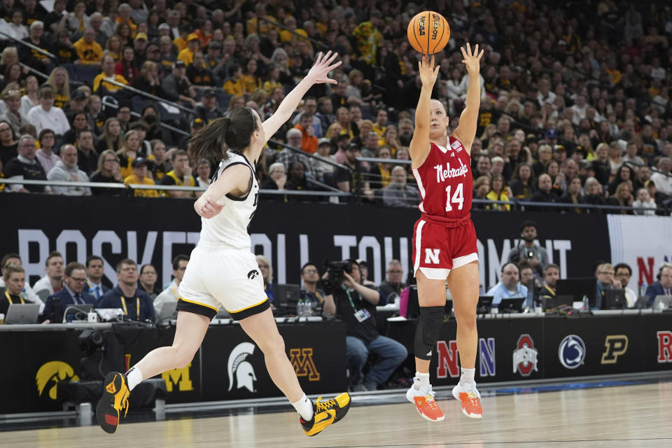 Nebraska guard Callin Hake (14) shoots over Iowa guard Caitlin Clark during the first half of an NCAA college basketball game in the final of the Big Ten women's tournament Sunday, March 10, 2024, in Minneapolis. (AP Photo/Abbie Parr)