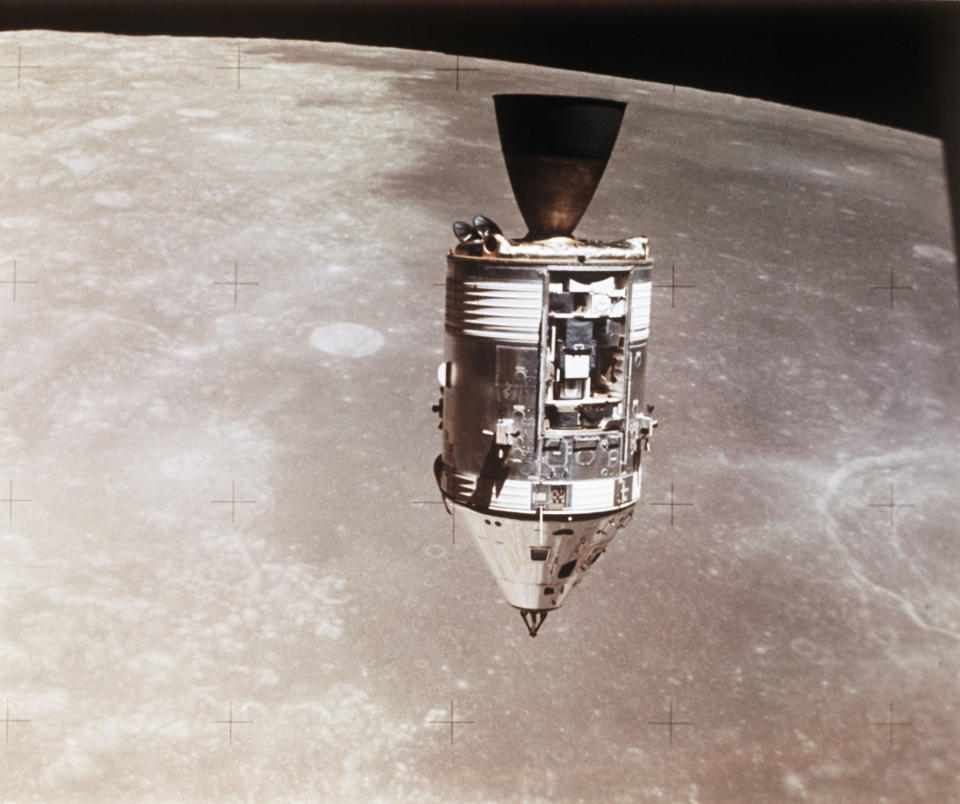 This August 1971 photo made available by NASA shows the Apollo 15 command and service modules in lunar orbit seen from the lunar module, with the lunar surface below. (NASA via AP)