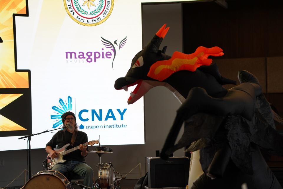 Oklahoma one-man band musician Mike Hosty shares the stage with a dragon at IndigiPopX 2023. Hosty will perform at IndigiPopX 2024, set for April 12-14 at First Americans Museum in Oklahoma City.