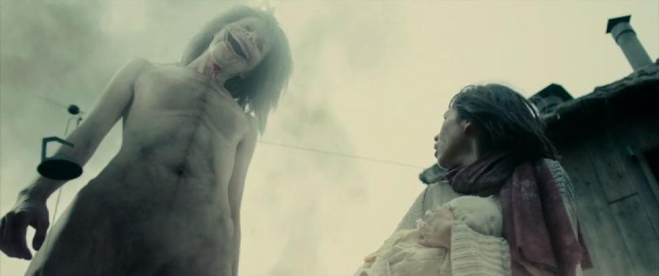 A Titan looms over a helpless Mikasa (Kiko Mizuhara) in Attack on Titan. Credit: Milady's Stuff