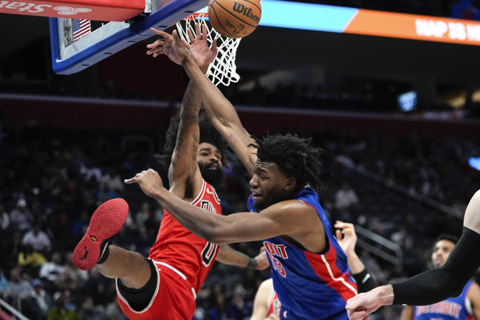 Chicago Bulls guard Coby White (0) defends Detroit Pistons center James Wiseman (13) in the second half of an NBA basketball game in Detroit, Thursday, April 11, 2024. (AP Photo/Paul Sancya)