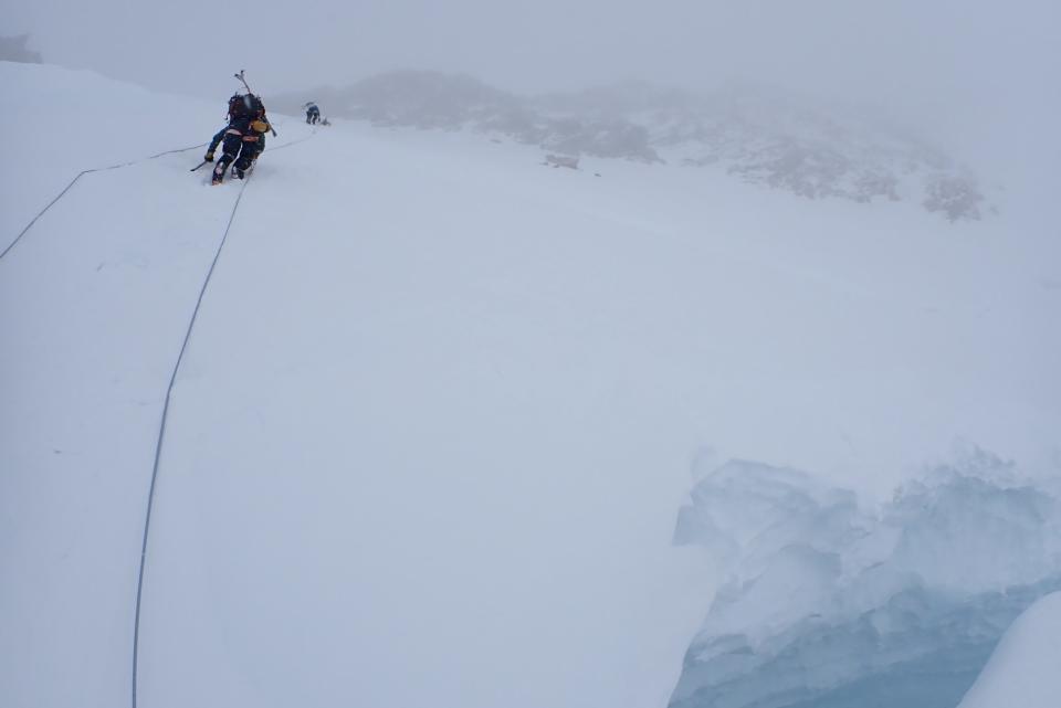 Climbers taking on the exposed headwall above 14 Camp.