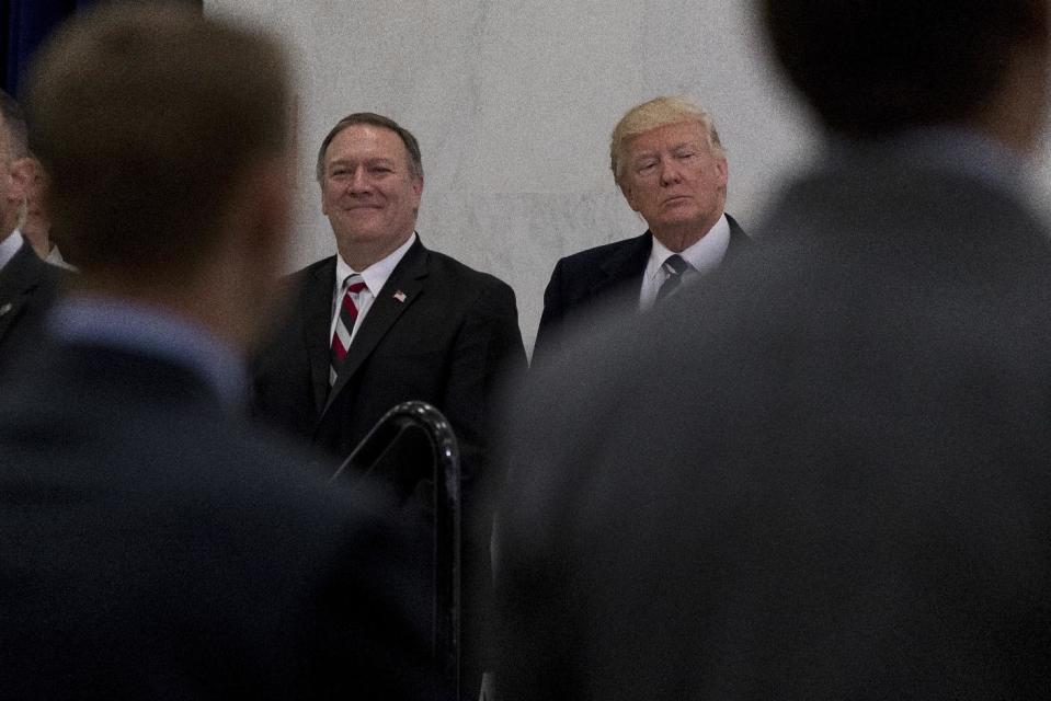 President Donald Trump, accompanied by CIA Director-designate Mike Pompeo, left, waits to speak at the Central Intelligence Agency in Langley, Va., Saturday, Jan. 21, 2017. (AP Photo/Andrew Harnik)