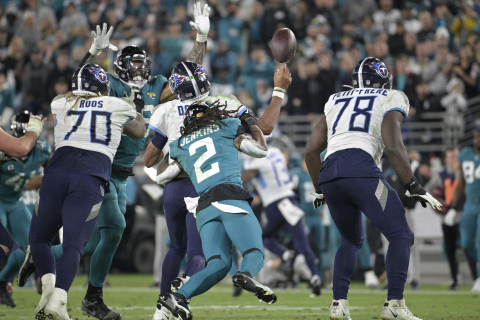 Tennessee Titans quarterback Joshua Dobbs fumbles as he is hit by Jacksonville Jaguars safety Rayshawn Jenkins (2), resulting in Jacksonville returning the fumble for a touchdown, in the second half of an NFL football game, Saturday, Jan. 7, 2023, in Jacksonville, Fla. (AP Photo/Phelan M. Ebenhack)