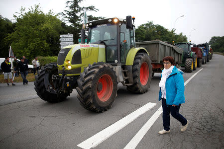 Christiane Lambert, President of France's farmer's union group FNSEA, walks past tractors during a protest by French farmers to block the French oil giant Total refinery in Donges, France, June 11, 2018. REUTERS/Stephane Mahe