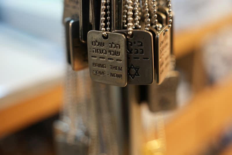 Military-style dog tags calling for the return of Israeli hostages who have been held in the Gaza Strip since they were seized by Hamas gunmen on October 7, are displayed at a stall in Mahane Yehuda market in Jerusalem