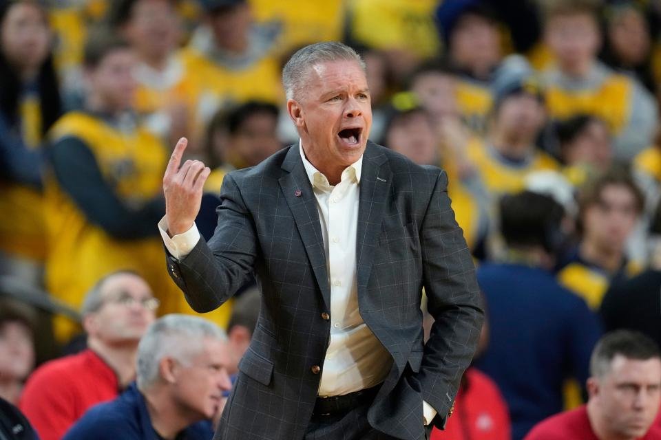 Ohio State head coach Chris Holtmann watches against Michigan in the first half of an NCAA college basketball game in Ann Arbor, Mich., Monday, Jan. 15, 2024. (AP Photo/Paul Sancya)