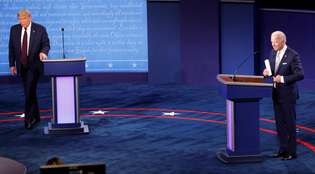 U.S. President Donald Trump and Democratic presidential nominee Joe Biden are seen on stage after the first 2020 presidential campaign debate held on the campus of the Cleveland Clinic at Case Western Reserve University in Cleveland, Ohio, U.S., September 29, 2020. REUTERS/Brian Snyder