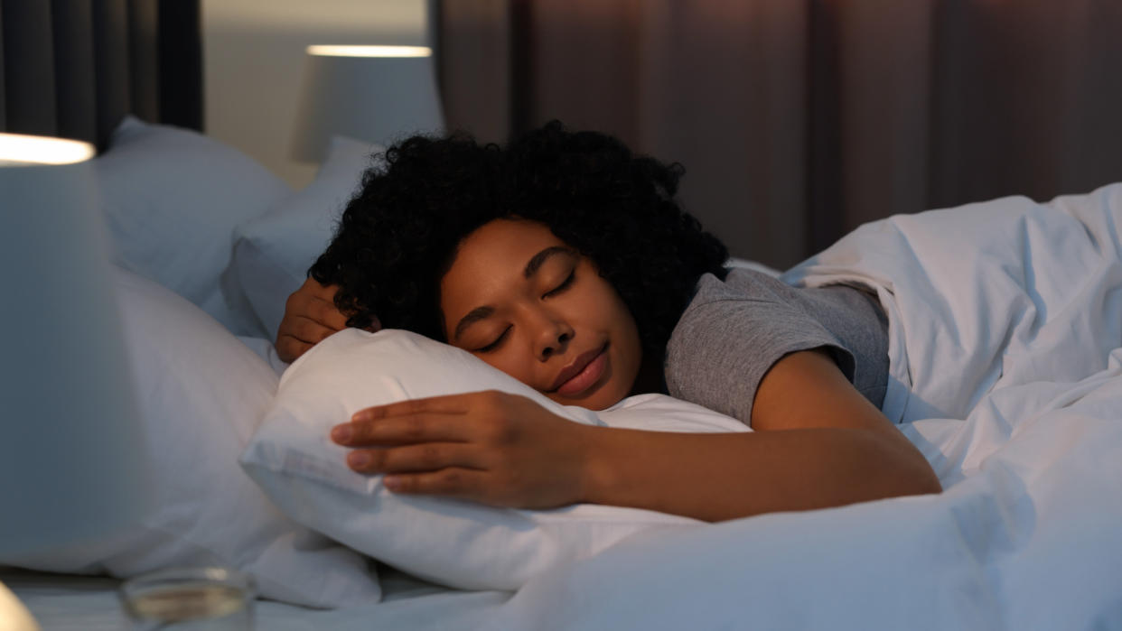  A woman sleeping in a bed . 