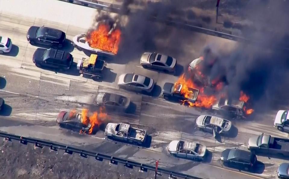 Frame grab from video of cars burning on Interstate 15 during a brush fire in the Cajon Pass, California