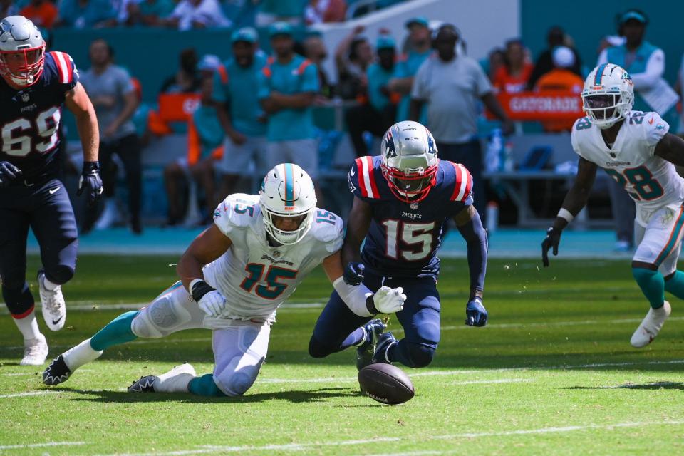 Miami Dolphins linebacker Jaelan Phillips (15) and New England Patriots wide receiver Nelson Agholor (15) reach for a fumbled ball during the game between the New England Patriots and host Miami Dolphins at Hard Rock Stadium in Miami Gardens, FL, on Sunday, September 11, 2022. Final score, Dolphins, 20, Patriots, 7.