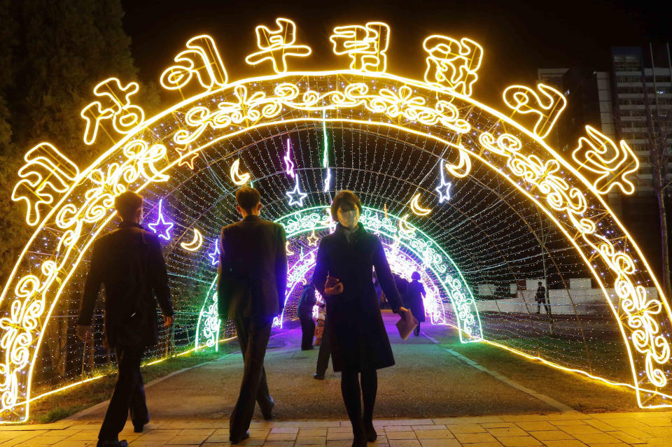 Citizens visit a light festival in celebration of 110th birth anniversary of their late leader Kim Il Sung at Kim Il Sung Square in Pyongyang, North Korea Thursday, April 14, 2022. The lighting letters read "We are the happiest in the world." (AP Photo/Jon Chol Jin)