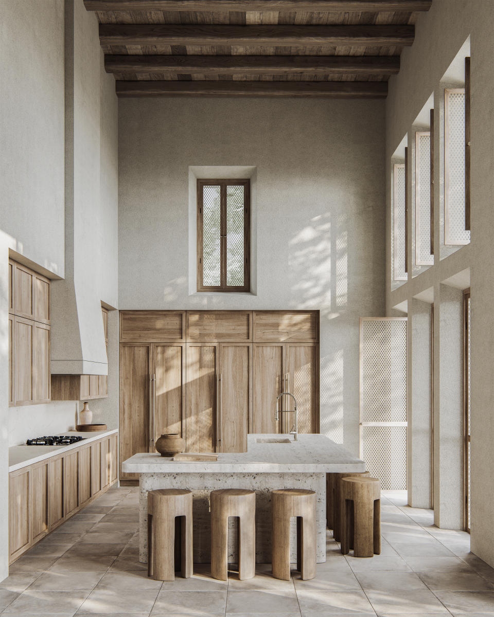 A double height kitchen with wooden ceiling, cabinetry and stools, and a marble island