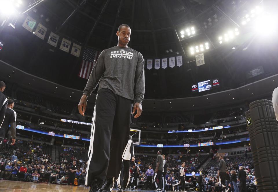 Brooklyn Nets center Jason Collins warms up before facing the Denver Nuggets in an NBA basketball game in Denver on Thursday, Feb. 27, 2014. (AP Photo/David Zalubowski)