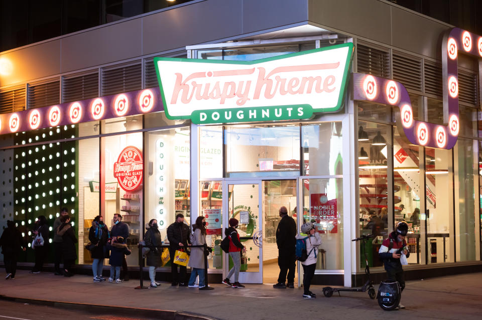 NEW YORK, NEW YORK - MARCH 17: People line up outside Krispy Kreme in Times Square amid the coronavirus pandemic on March 17, 2021 in New York City. After undergoing various shutdown orders for the past 12 months the city is currently in phase 4 of its reopening plan, allowing for the reopening of low-risk outdoor activities, movie and television productions, indoor dining as well as the opening of movie theaters, all with capacity restrictions. (Photo by Noam Galai/Getty Images)