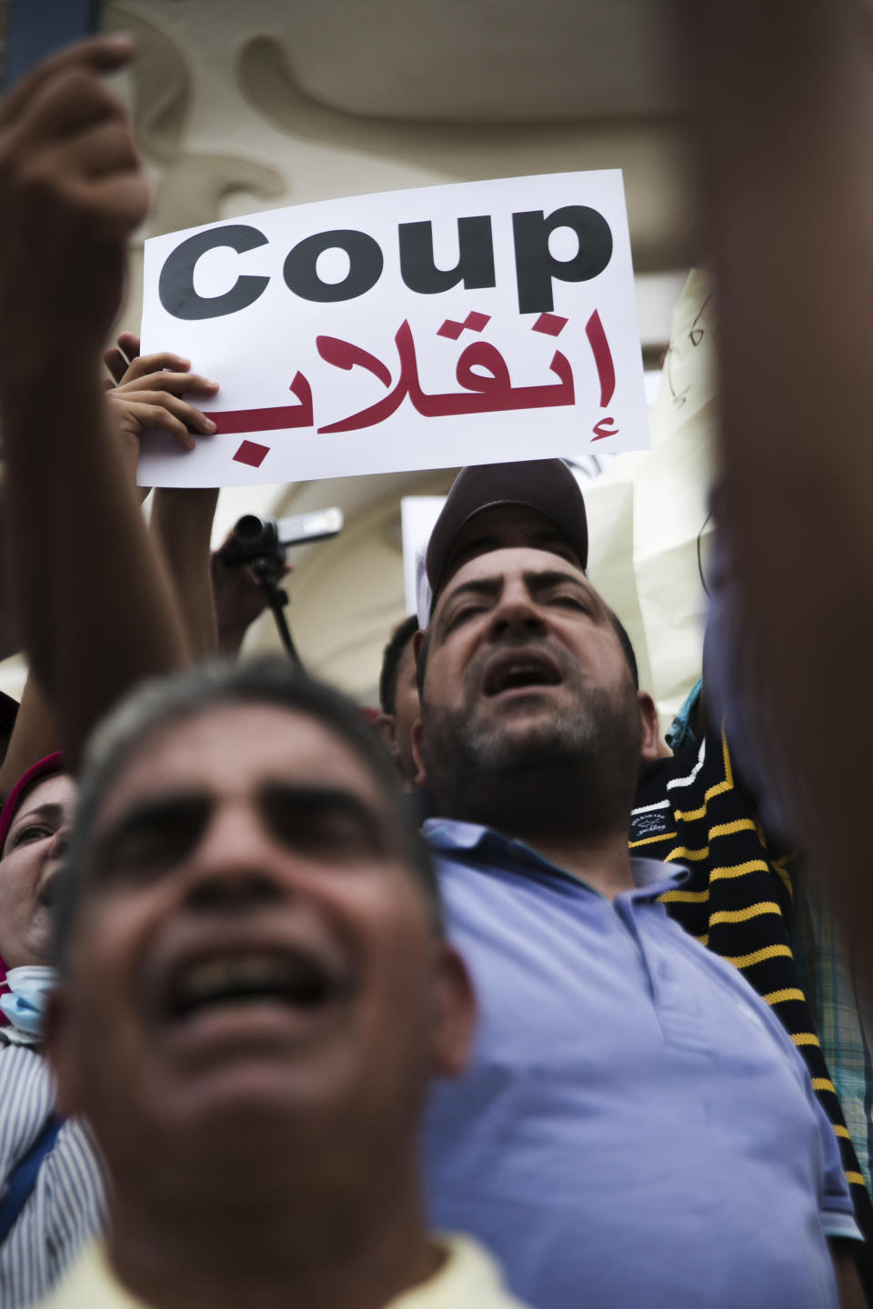 Tunisian demonstrators gather outside the Municipal Theatre of Tunis during a protest against Tunisian President Kais Saied, Saturday, Sept. 18, 2021. In July Tunisian President Kais Saied fired the country's prime minister and froze parliament's activities after violent demonstrations over the country's pandemic and economic situation. The movement made by Saied was considered by his opponents as a coup. (AP Photo/Riadh Dridi)