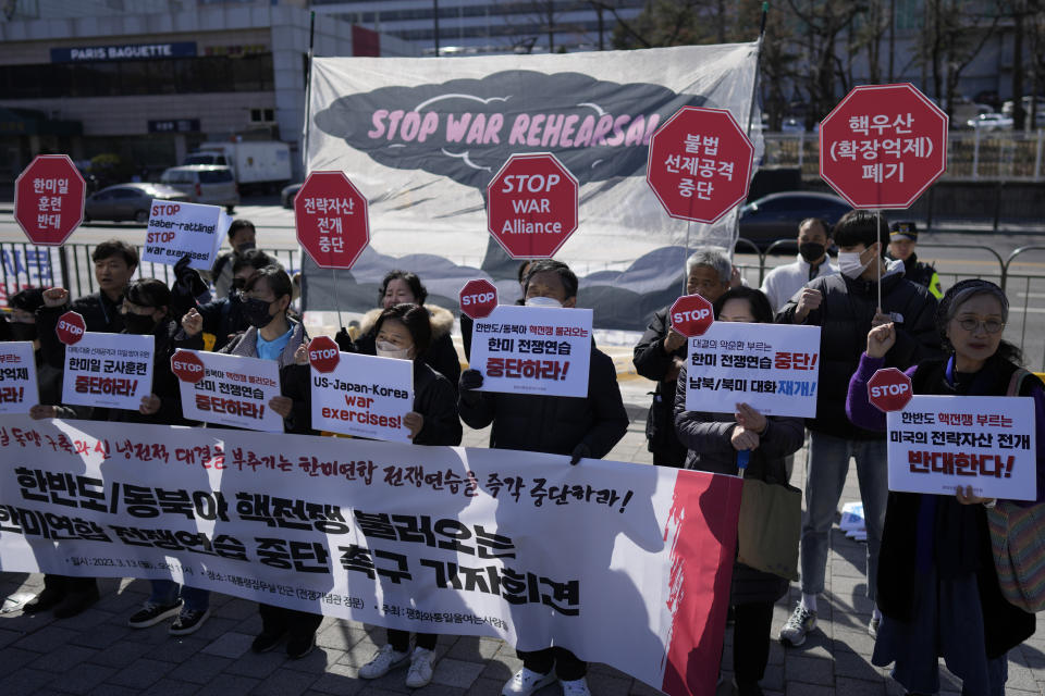 Protesters shout slogans during a rally to oppose the planned joint military exercises between the U.S. and South Korea in Seoul, South Korea, Monday, March 13, 2023. The South Korean and U.S. militaries launched their biggest joint military exercises in years Monday, as North Korea said it conducted submarine-launched cruise missile tests in apparent protest of the drills it views as an invasion rehearsal. The letters read "Stop, the joint war exercises between the U.S. and South Korea." (AP Photo/Lee Jin-man)