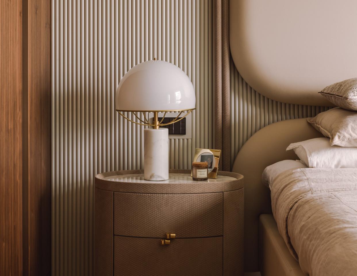  A bedside lamp in a neutral bedroom. 